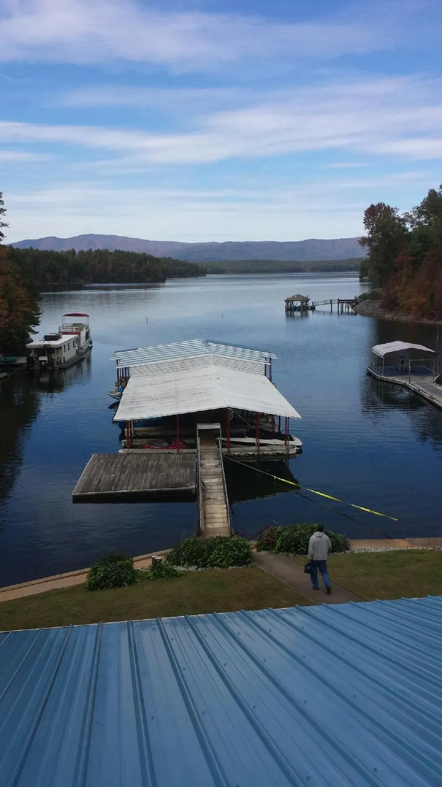 View across a lake from a newly installed blue metal roof in Geneva
