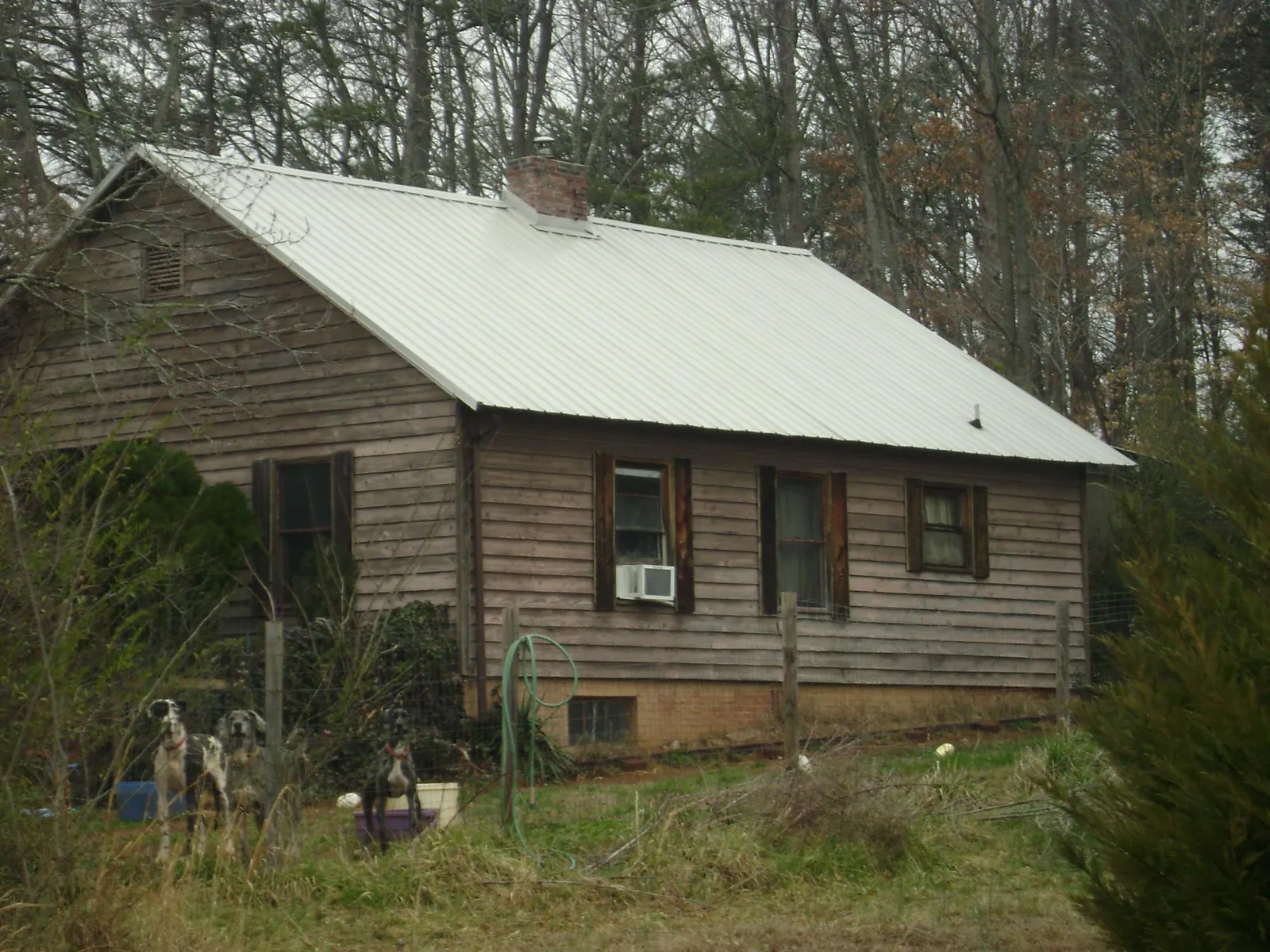 White metal roof on an old wood sided farmhouse, from a Metal Roof Installation job in Geneva